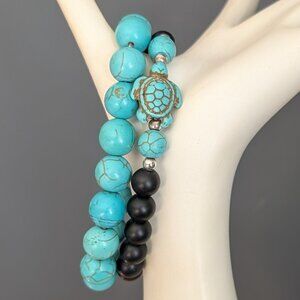 2 faux turquoise and black bead stretch layering bracelets with turtle accent